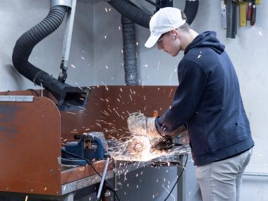 Dreng skærer i metal